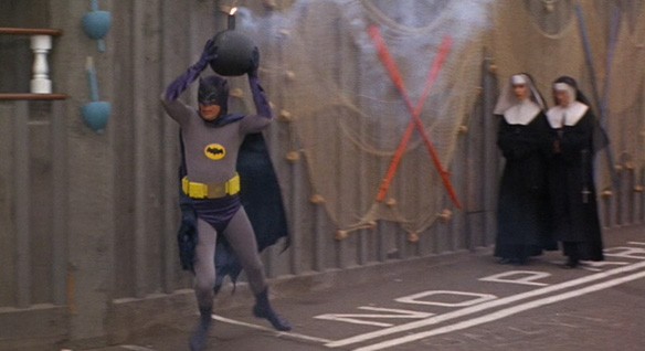Batman carrying a bomb